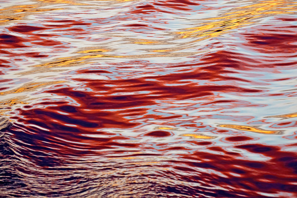 Water ripples in red sunset. Photography by Allison Maltese